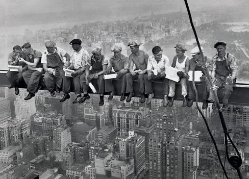 men sitting on crane high rise lunch atop a crane